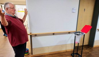 Ein Bewohner freut sich über seinen erfolgreichen Wurf in den Korb. Beim Sporttag in der ProCurand Seniorenresidenz Havelpalais hatten alle viel Spaß, auch wenn das Wetter nicht optimal war.