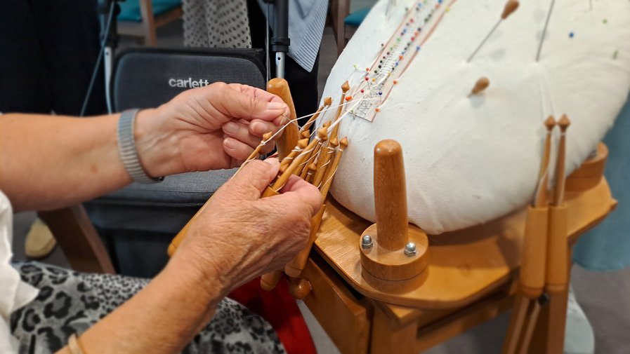Close-up auf die Klöppelarbeiten in der Residenz Am Hallorenring – ein Work-in-Progress, bei dem filigrane Muster und feine Fäden deutlich werden. Schon zu DDR-Zeiten waren solche kunstvollen Stücke in den Kunsthandwerkerläden sehr begehrt.