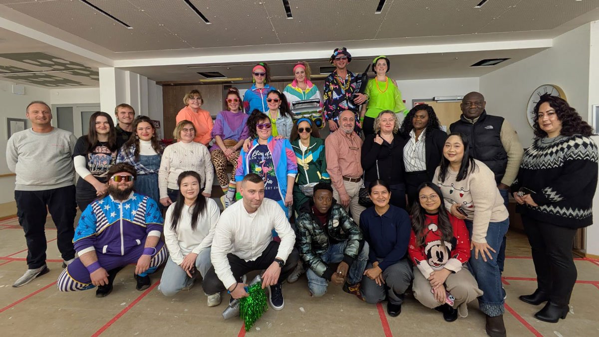 Kolleg*innen feiern die 80er-Jahre-Party im Café Havelblick der ProCurand Seniorenresidenz Havelpalais.