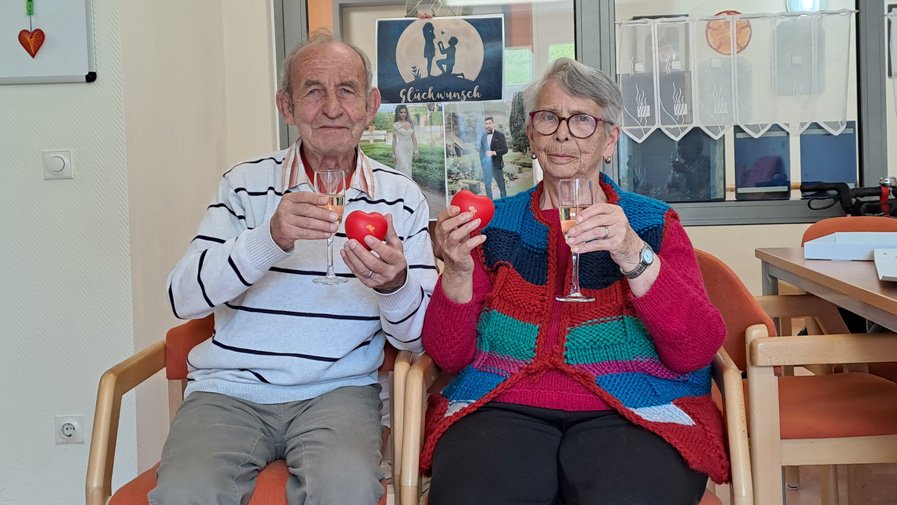 Gemeinsam mit ProCurand-Herzen stoßen Detlef und Marianne auf ihre Verlobung an und feiern die Liebe in ihrer Einrichtung.